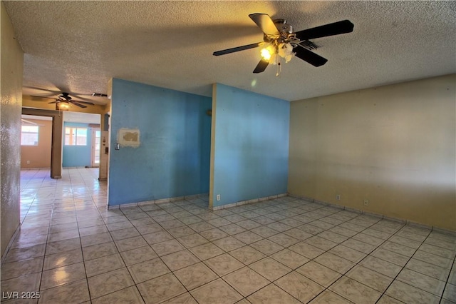 unfurnished room with light tile patterned floors, visible vents, a textured ceiling, and ceiling fan