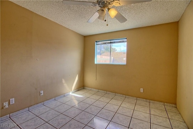 unfurnished room featuring a textured ceiling, light tile patterned floors, and ceiling fan