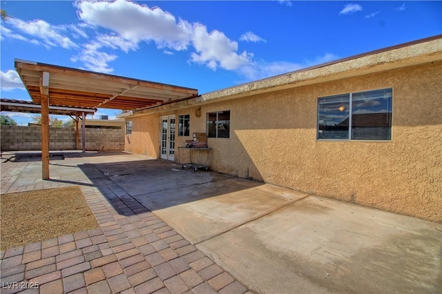 view of patio / terrace with french doors and fence