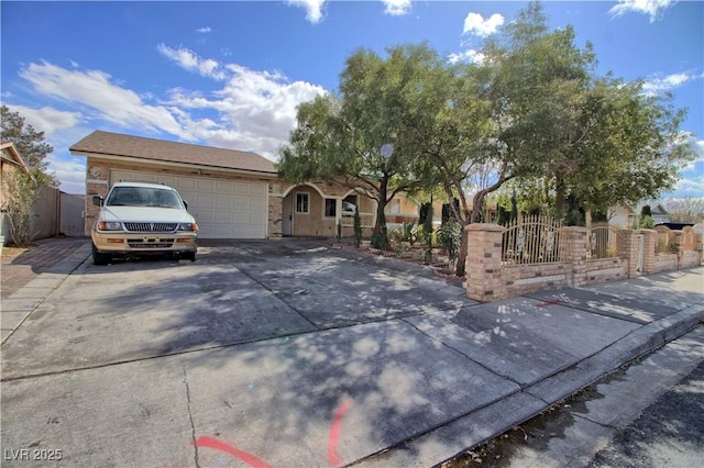 ranch-style house with driveway, a gate, a garage, and a fenced front yard