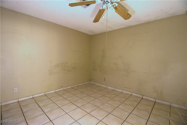 unfurnished room featuring light tile patterned floors and a ceiling fan