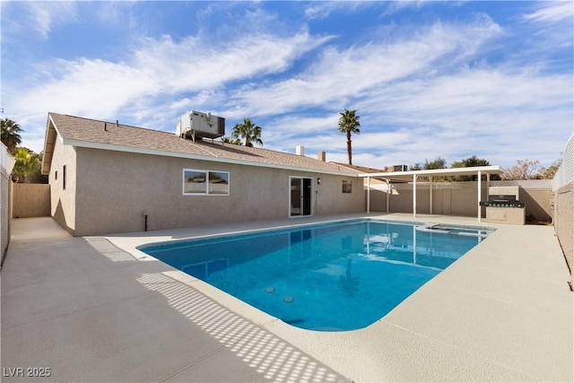 view of swimming pool with central AC unit, a patio, a pool with connected hot tub, and a fenced backyard