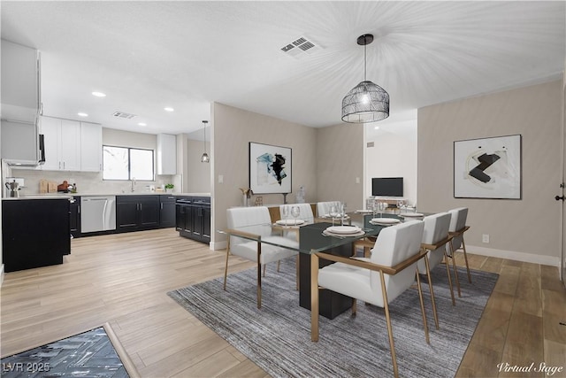 dining room featuring recessed lighting, baseboards, visible vents, and light wood finished floors