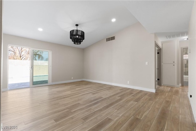 unfurnished room with visible vents, an inviting chandelier, baseboards, and light wood-style floors