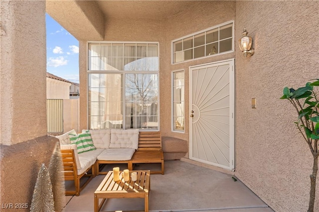 exterior space with outdoor lounge area, a patio, and stucco siding