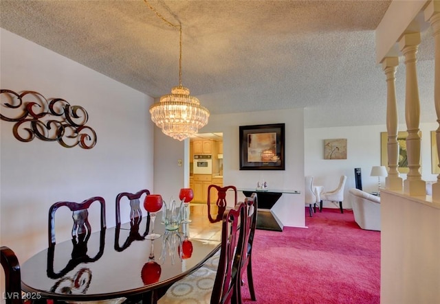 dining space with a notable chandelier, carpet flooring, and a textured ceiling