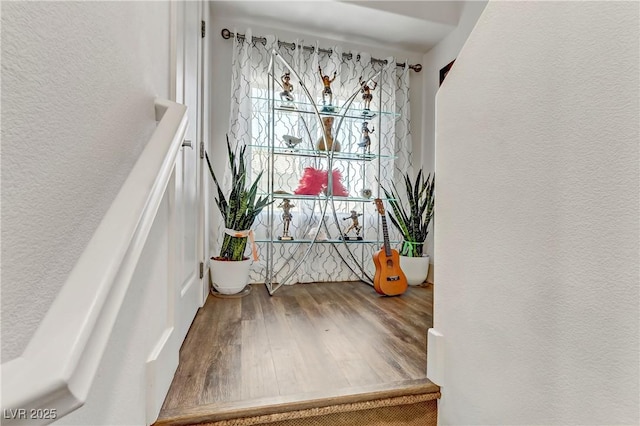 details with a textured wall and wood finished floors