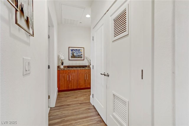 hallway with visible vents, recessed lighting, and light wood-style floors