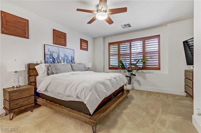 bedroom featuring a ceiling fan, light colored carpet, visible vents, and baseboards