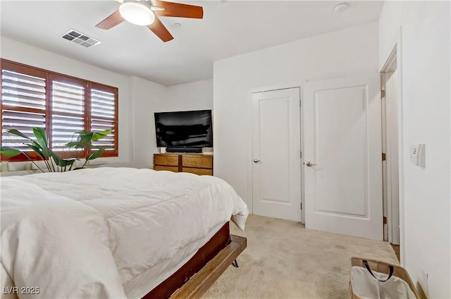 bedroom featuring visible vents, light carpet, and ceiling fan