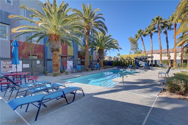 community pool featuring a patio area and fence