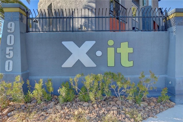 community / neighborhood sign with fence