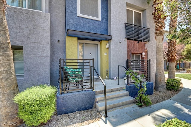 entrance to property featuring stucco siding