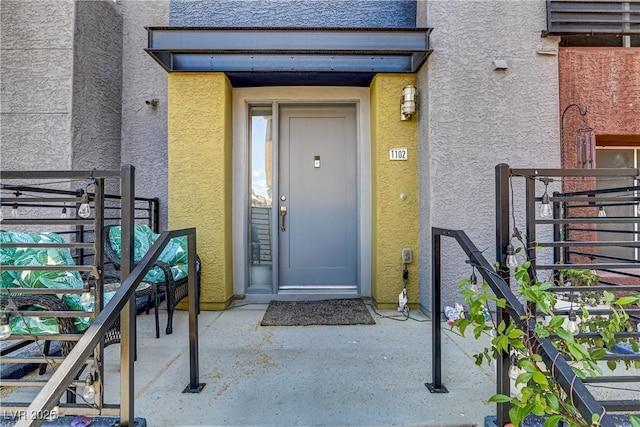 property entrance featuring stucco siding