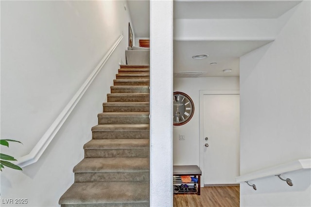 staircase with wood finished floors