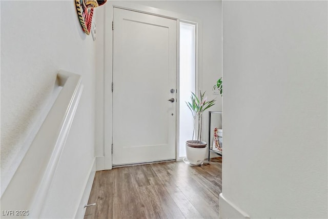 entryway with wood finished floors