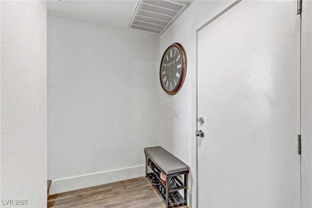 interior space featuring light wood-style floors, visible vents, and baseboards