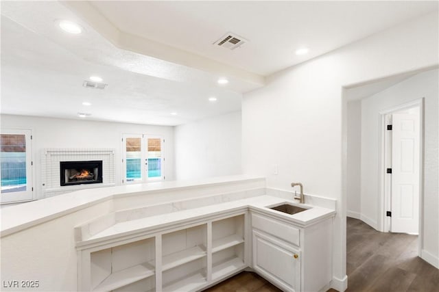 kitchen featuring a sink, visible vents, recessed lighting, and light countertops