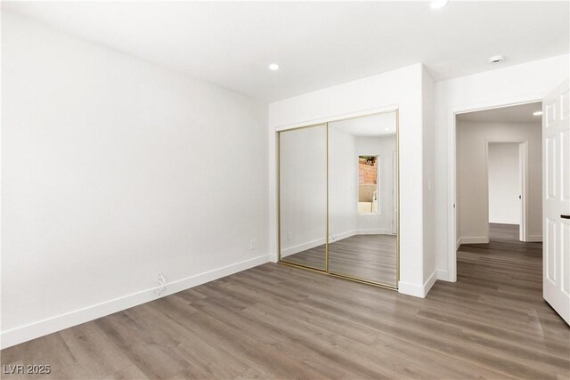 3021 Ocean Port Dr, Las Vegas, NV 89117 - unfurnished bedroom featuring light wood-style floors, recessed lighting, baseboards, and a closet