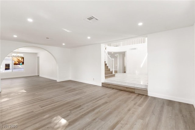 unfurnished room with visible vents, baseboards, stairs, recessed lighting, and wood finished floors