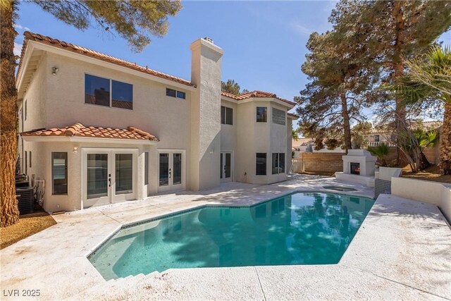 back of property featuring a fenced backyard, stucco siding, french doors, and a patio