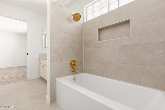 full bathroom featuring tub / shower combination, baseboards, vanity, and tile patterned flooring