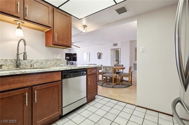 kitchen with light tile patterned floors, visible vents, appliances with stainless steel finishes, and a sink