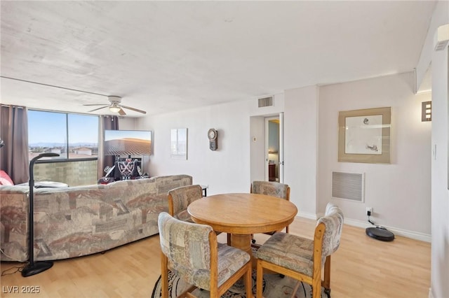 dining area with visible vents, baseboards, and wood finished floors