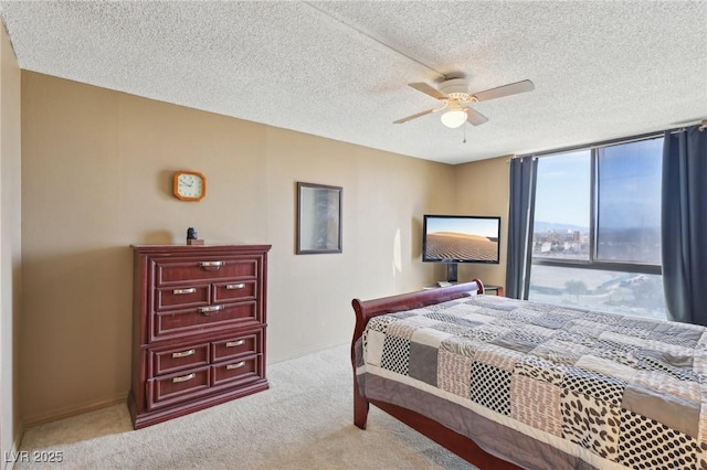 carpeted bedroom with baseboards, a textured ceiling, and ceiling fan