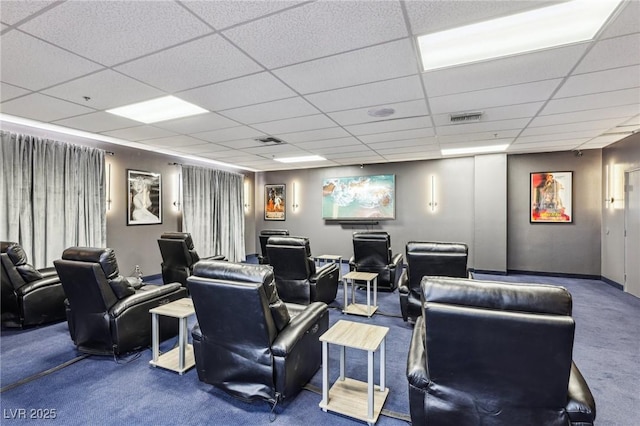 home theater room featuring carpet, visible vents, and a drop ceiling