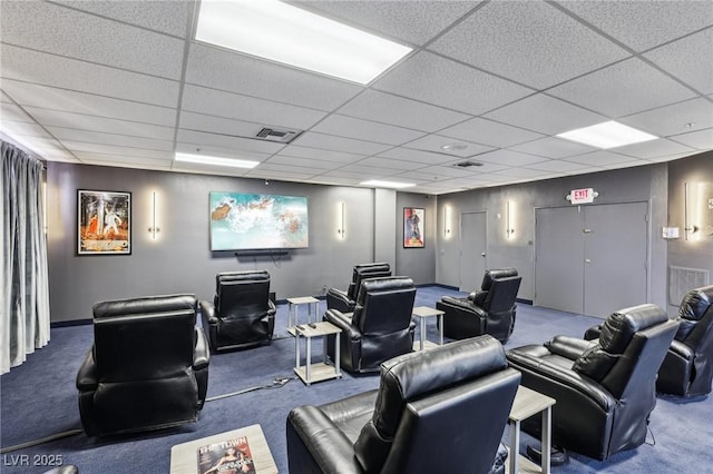 carpeted home theater room with visible vents and a drop ceiling