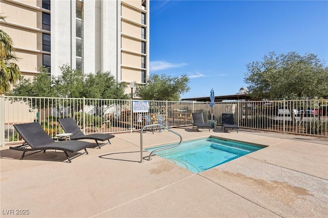 view of pool with a patio and fence