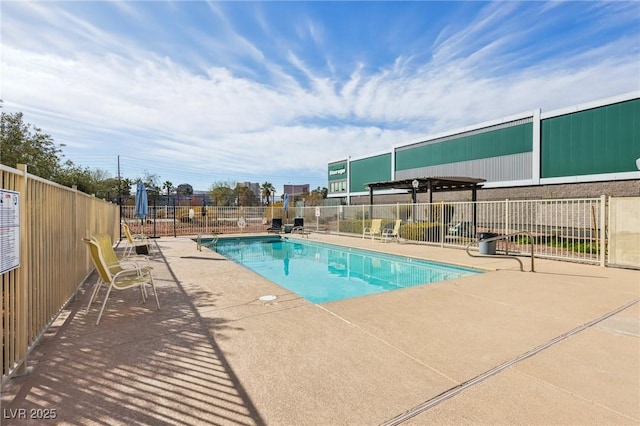 community pool with a patio and fence