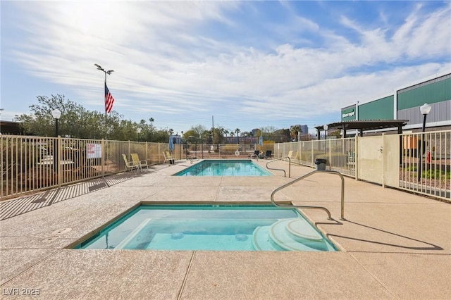 community pool featuring a community hot tub, a patio area, and fence