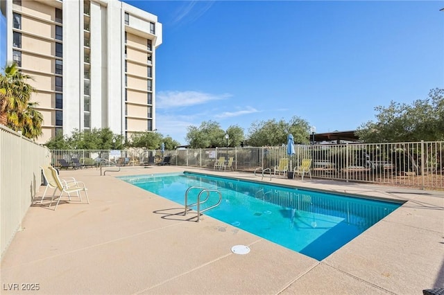 community pool featuring a patio area and fence