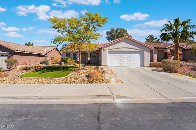 view of front of home with stucco siding, a front lawn, driveway, a tile roof, and an attached garage