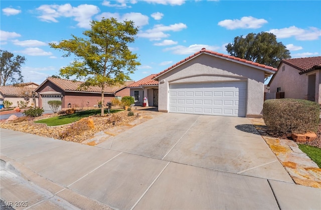 mediterranean / spanish-style house featuring a tile roof, an attached garage, driveway, and stucco siding