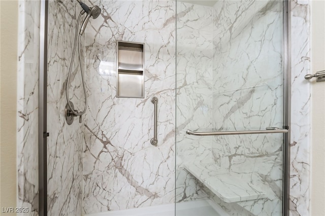 bathroom with a marble finish shower