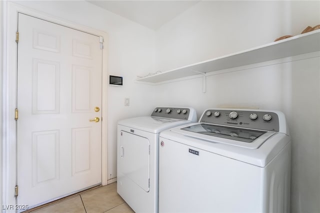 laundry room with light tile patterned floors, laundry area, and washing machine and dryer