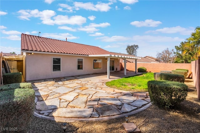 back of property featuring stucco siding, a patio area, a fenced backyard, and a tile roof