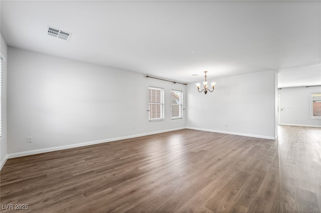 206 Lynbrook St, Henderson, NV 89012 - unfurnished room featuring a chandelier, plenty of natural light, and dark wood-style floors