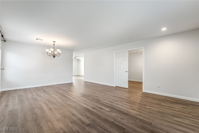 206 Lynbrook St, Henderson, NV 89012 - empty room with a chandelier, dark wood-style floors, and recessed lighting