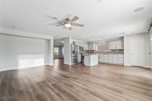 206 Lynbrook St, Henderson, NV 89012 - unfurnished living room featuring ceiling fan, wood finished floors, and recessed lighting