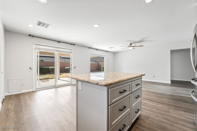 206 Lynbrook St, Henderson, NV 89012 - kitchen featuring gray cabinetry, a center island, wood finished floors, ceiling fan, and recessed lighting