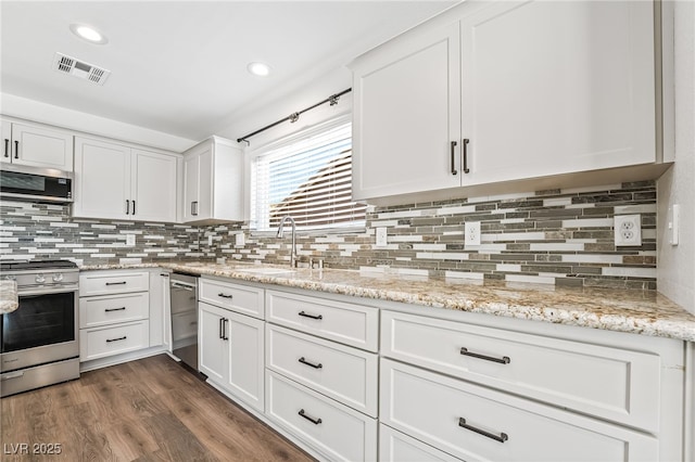 206 Lynbrook St, Henderson, NV 89012 - kitchen featuring appliances with stainless steel finishes, white cabinetry, decorative backsplash, and recessed lighting