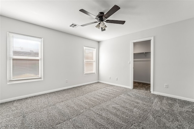 206 Lynbrook St, Henderson, NV 89012 - unfurnished bedroom with carpet, a walk in closet, a ceiling fan, and a closet