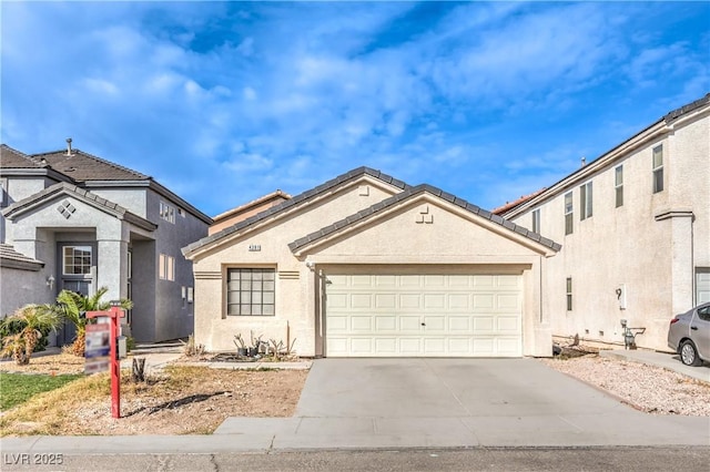 view of front of property featuring a garage, driveway, and stucco siding