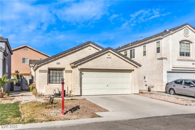 view of front facade with stucco siding, driveway, and a garage