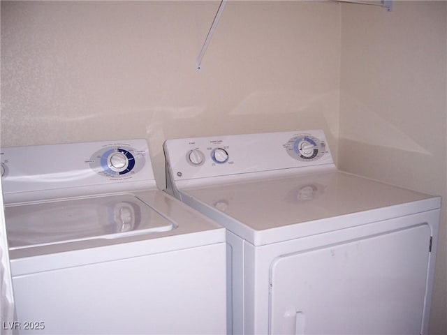 washroom featuring laundry area and washing machine and clothes dryer