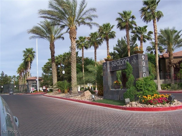 view of road featuring curbs and a gated entry